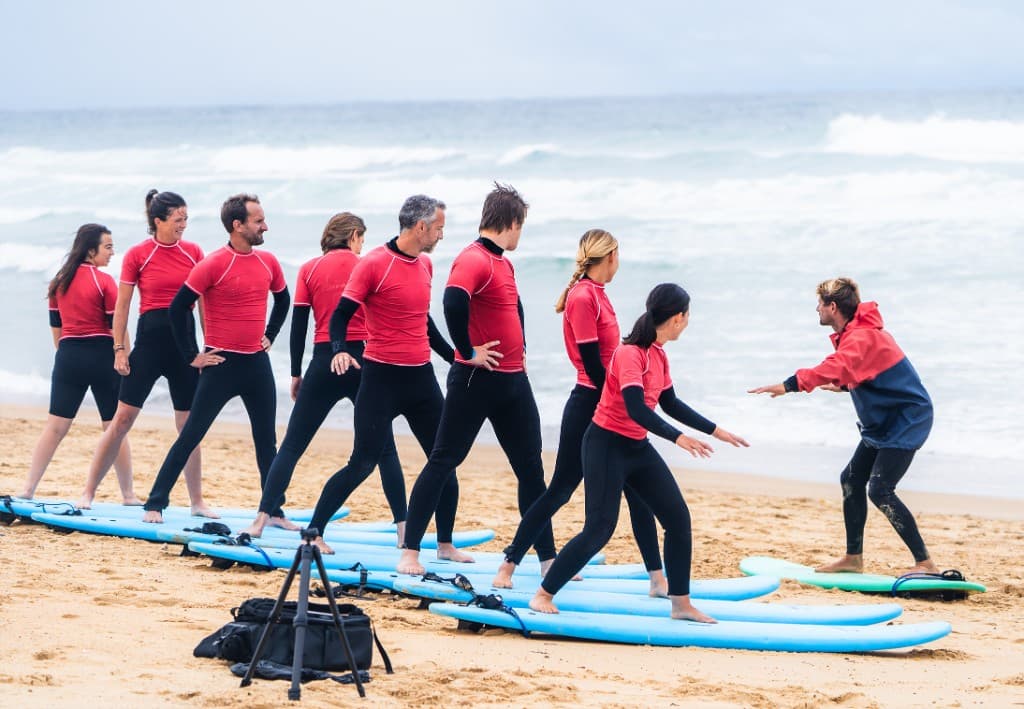 Surf lesson on the beach — school and photographer