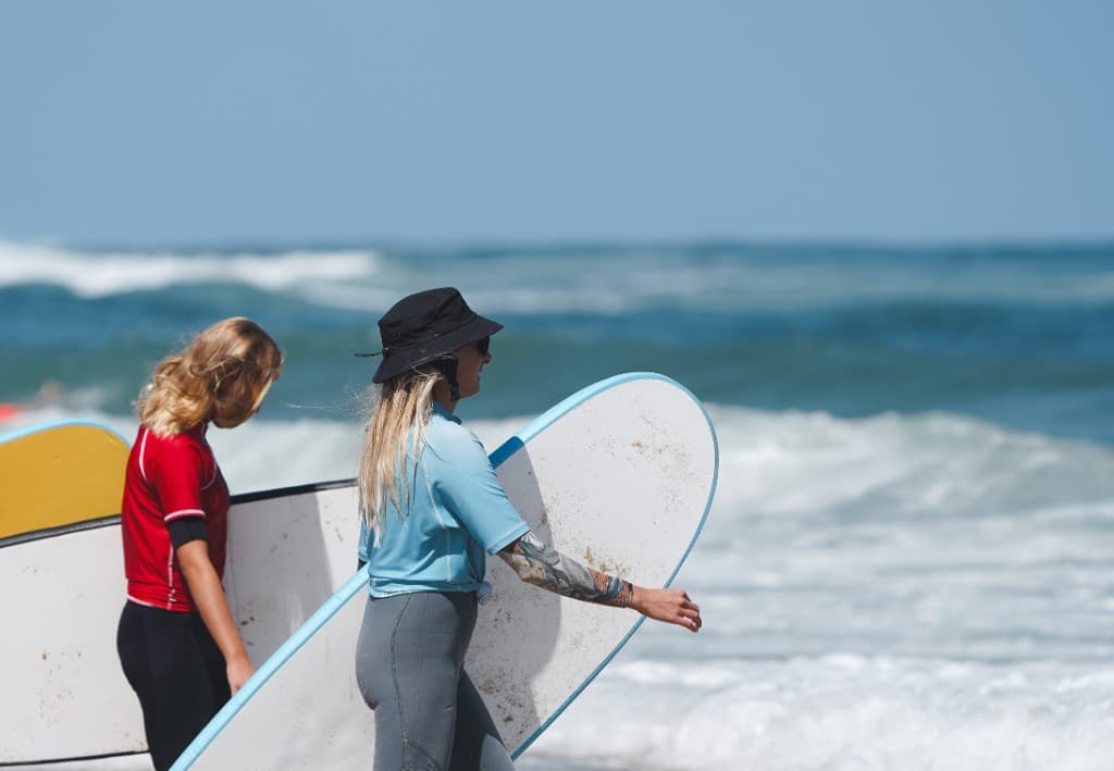 Surfers with boards on the beach